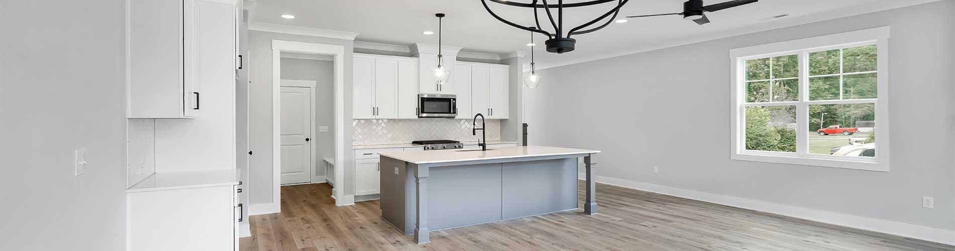 New home open concept with grey hardwood and black hardware